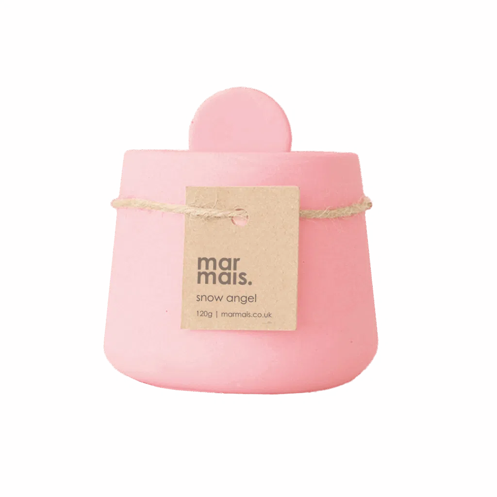 Pink handmade candle pot with lid and kraft tag reading โSnow Angel Candleโ minimalist design and pastel pink colour.