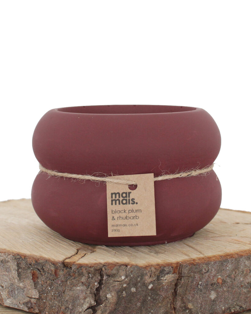 Large ribbed candle vessel in deep plum red, filled with Black Plum & Rhubarb fragrance by Marmais. Handmade with 280g natural rapeseed and coconut wax, double-wicked for a longer burn.
